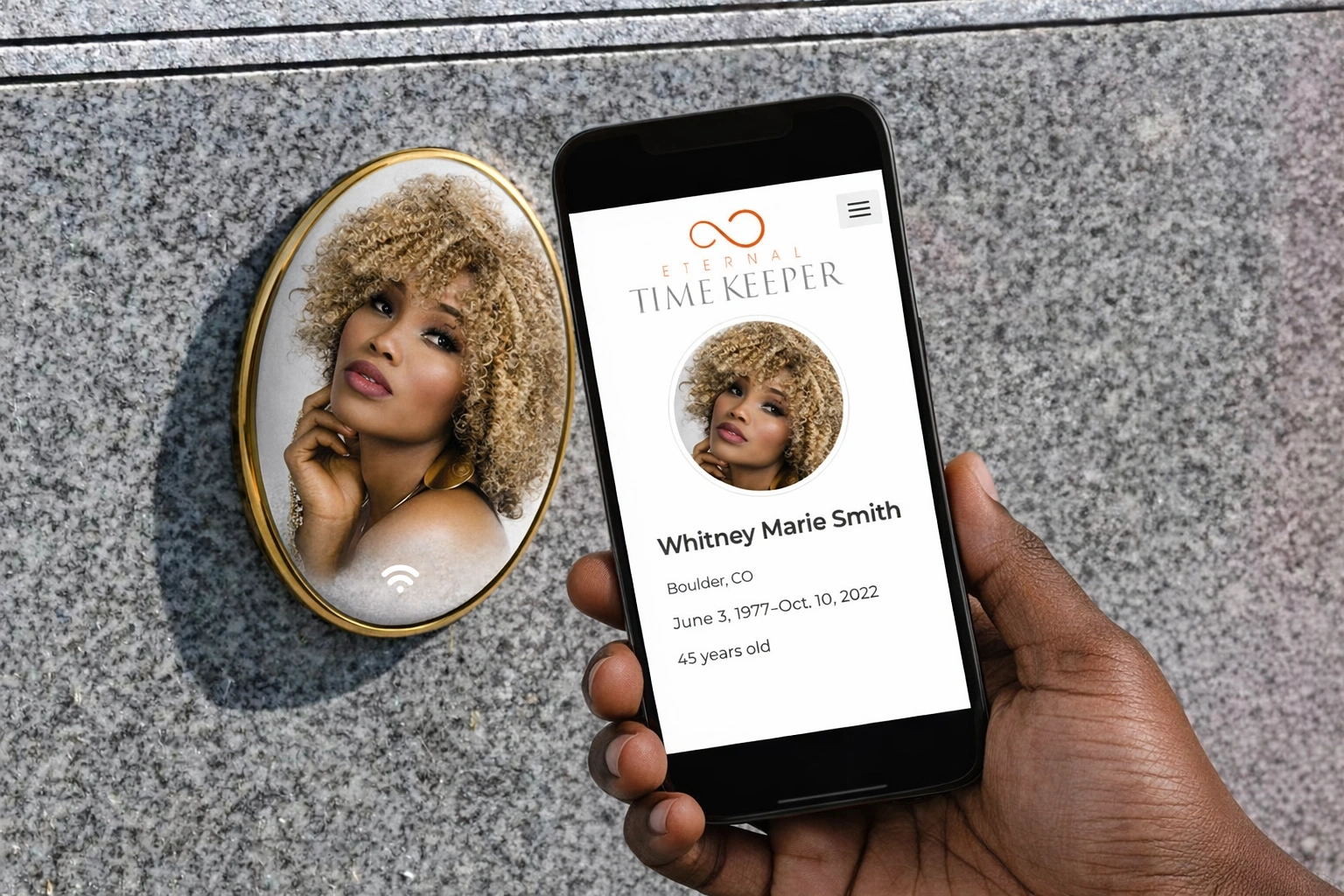 A phone held beside a gold-framed Porcelains Unlimited porcelain cameo on a granite monument, displaying the Eternal Timekeeper memorial profile