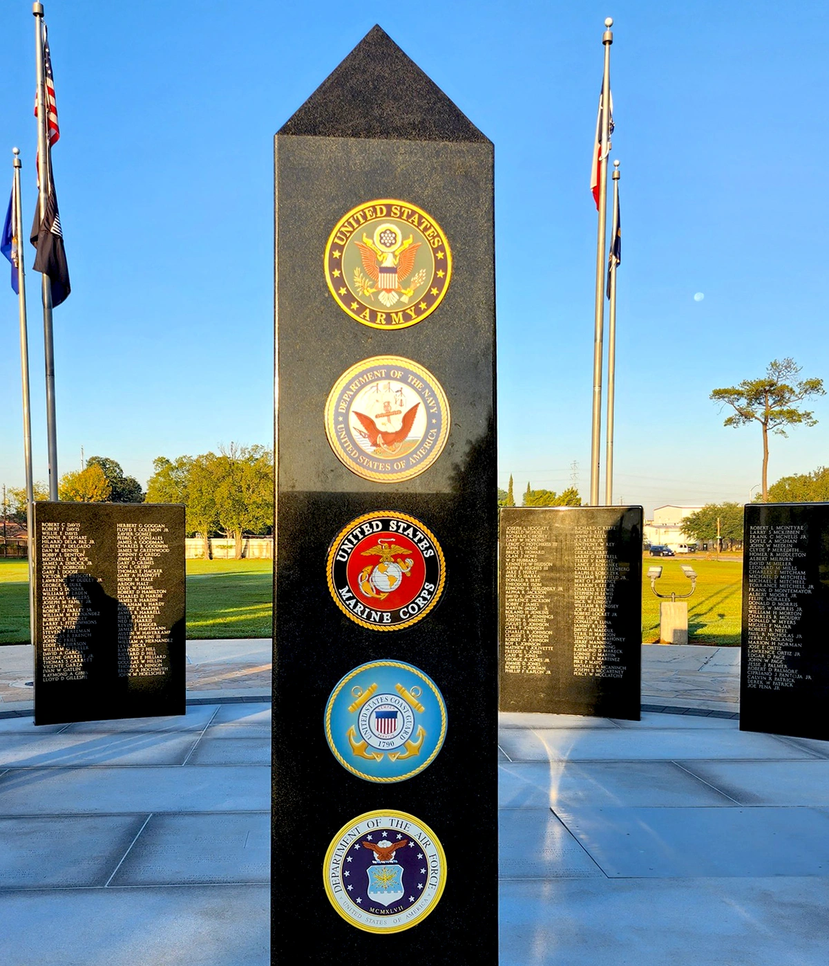Vietnam Fallen Warriors monument with porcelain seals of the five U.S. military branches set into a black granite obelisk